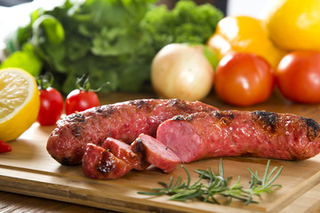 grilled meat sausages with potatoes and tomatoes