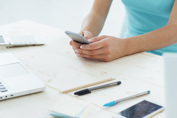 Fototapeta premium Teen girl texting with her mobile phone