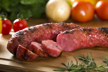 grilled meat sausages with potatoes and tomatoes