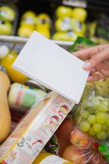 Woman writing in her notepad in aisle 