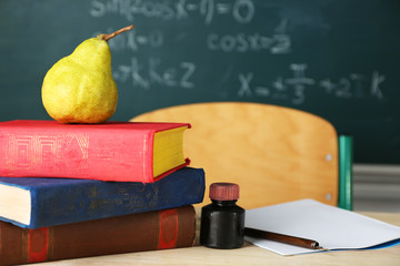 Teachers workplace  on blackboard background