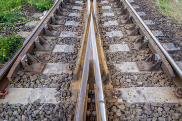 Fototapeta premium railroad tracks with railroad switch, two paths come together