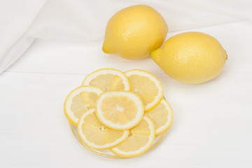 Lemons And Fresh Lemon Slices On A Plate