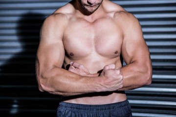Fototapeta na wymiar Muscular man with arms crossed