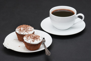 Cupcakes With Cocoa White Cream And Sprinkles. Cup Of Coffee