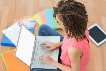 Young creative businesswoman working on laptop