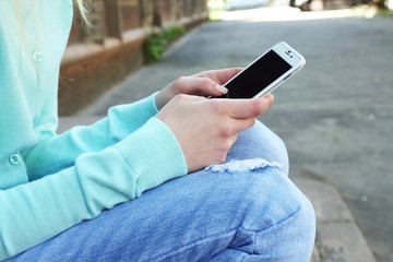 Woman with mobile phone, outdoors