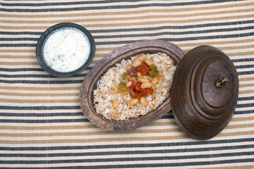 Turkish traditional meal, beans, rice, mixed pickles and tzatziki