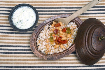 Turkish traditional meal, beans, rice, mixed pickles and tzatziki