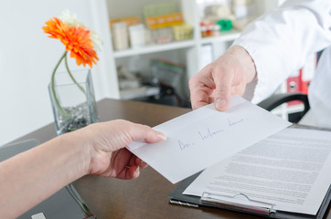 Doctor giving a prescription to his patient