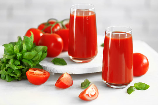 Tomato juice and fresh tomatoes on wooden table close-up © Africa Studio