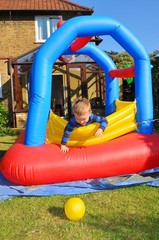 Child plays in a colorful bouncing castle