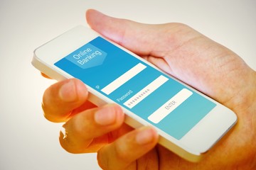 Composite image of hand holding smartphone