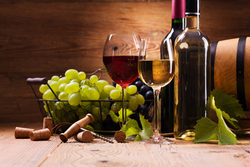 Glasses of red and white wine, served with grapes