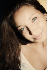 Obraz premium Young brunette woman with green eyes