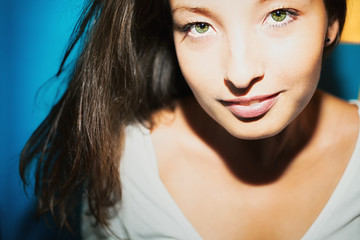 Obraz premium Young brunette woman with green eyes