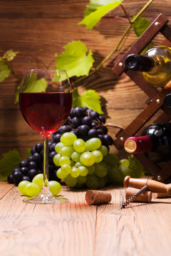 Glass of red wine, served with grapes