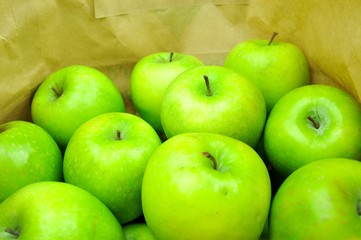 Close up of green apples in shopping bag