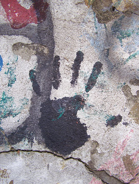 Black handprint on wall