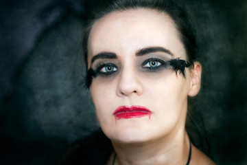 Woman with Halloween make up and smeared red lipstick