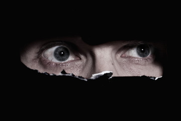 Scary eyes of a man spying