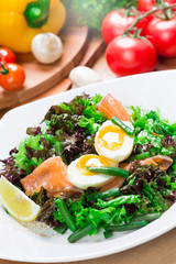 Fresh green salad with salmon and eggs