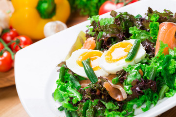 Fresh green salad with salmon and eggs