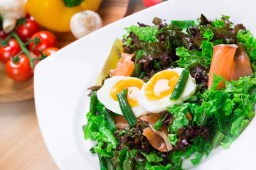 Fresh green salad with salmon and eggs