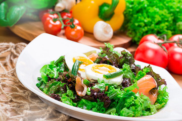 Fresh green salad with salmon and eggs