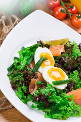 Fresh green salad with salmon and eggs