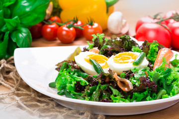 Fresh green salad with salmon and eggs