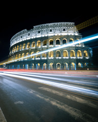 The Colosseum, Rome, Italy. A long-exposure, night view of the Colosseum with abstract traffic...