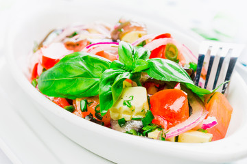 Fish salad with tomatoes and basil