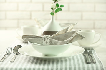 Beautiful holiday table setting in white and gray color