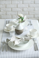 Fototapeta na wymiar Beautiful holiday table setting in white and gray color