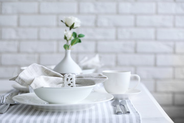 Beautiful holiday table setting in white and gray color