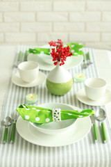 Beautiful holiday table setting in white and green color