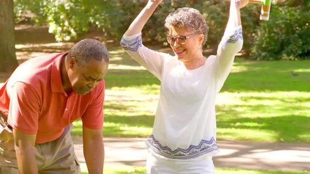 Mature Black Woman Celebrates while Playing Croquet in a Park