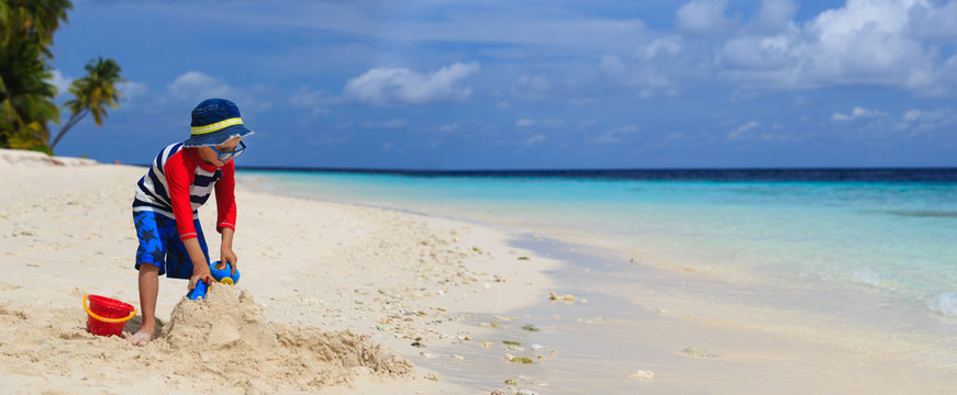 Little Boy Building Sandcastle On Tropical Beach