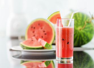 Glass of fresh watermelon juice on kitchen table
