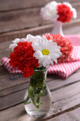 Beautiful flowers in vases on table close up