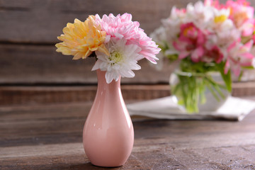 Beautiful flowers in vases on table close up