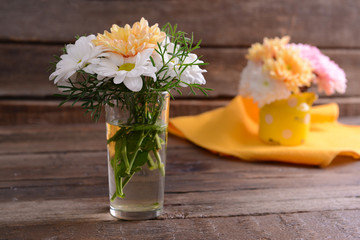 Beautiful flowers in vases on table close up