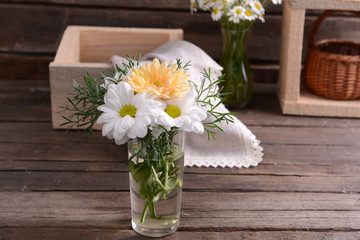 Beautiful flowers in vase on table close up