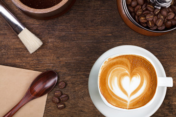 A cup of coffee on the brown wooden background