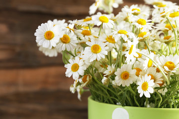 Beautiful bouquet of daisies in cup close up