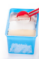 Ice cream scoop in ice cream close up on white background