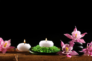 Obraz na płótnie Canvas Beautiful spa composition with flowers and candles on black background