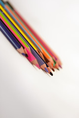 Colored pencils. / Set of pencils on a sheet of white paper.