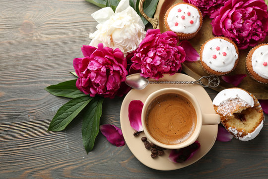 Fototapeta Composition with cup of coffee, muffins and peony flowers on wooden background